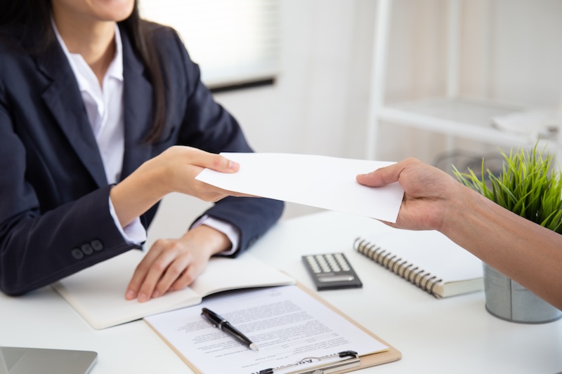 woman receiving envelope of money